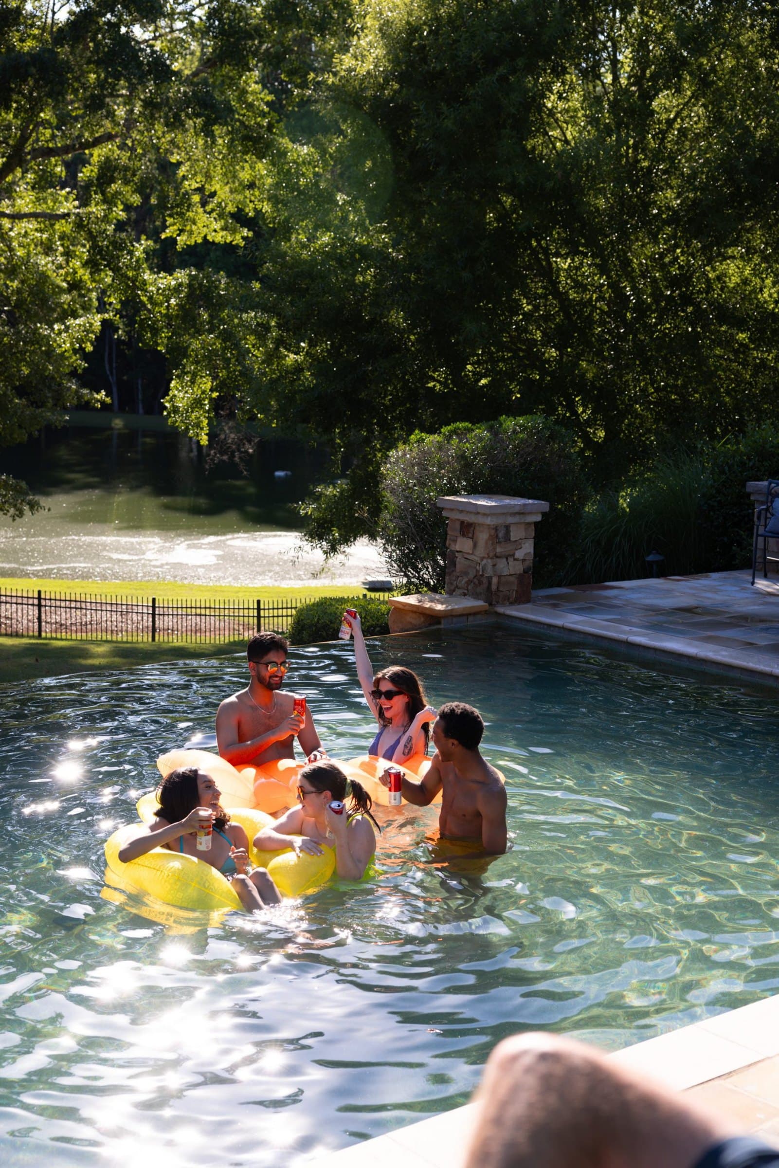Friends in a pool on floats