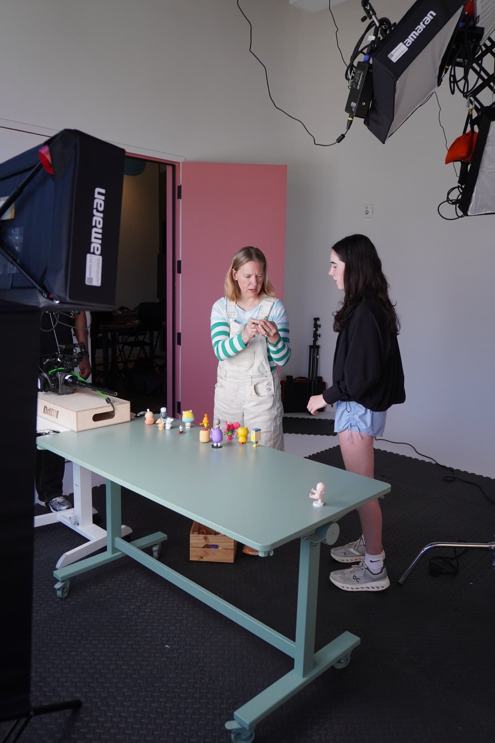 Setting up figures on a table in the studio